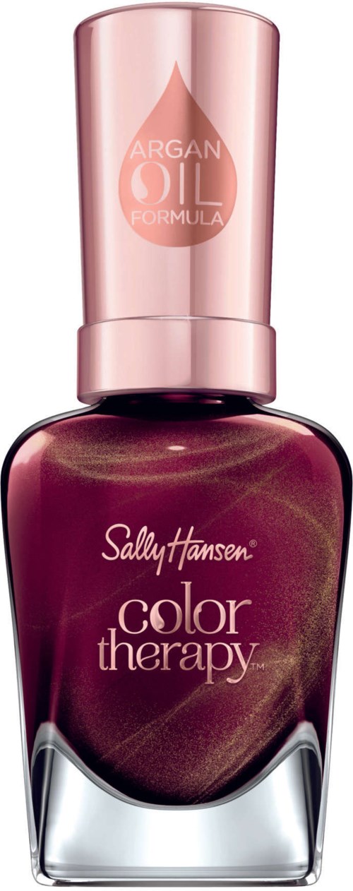En Sally Hansen nagellacksflaska i mörkrött med en rosa kork, märkt 'Color Therapy' och 'Argan Oil formula.'