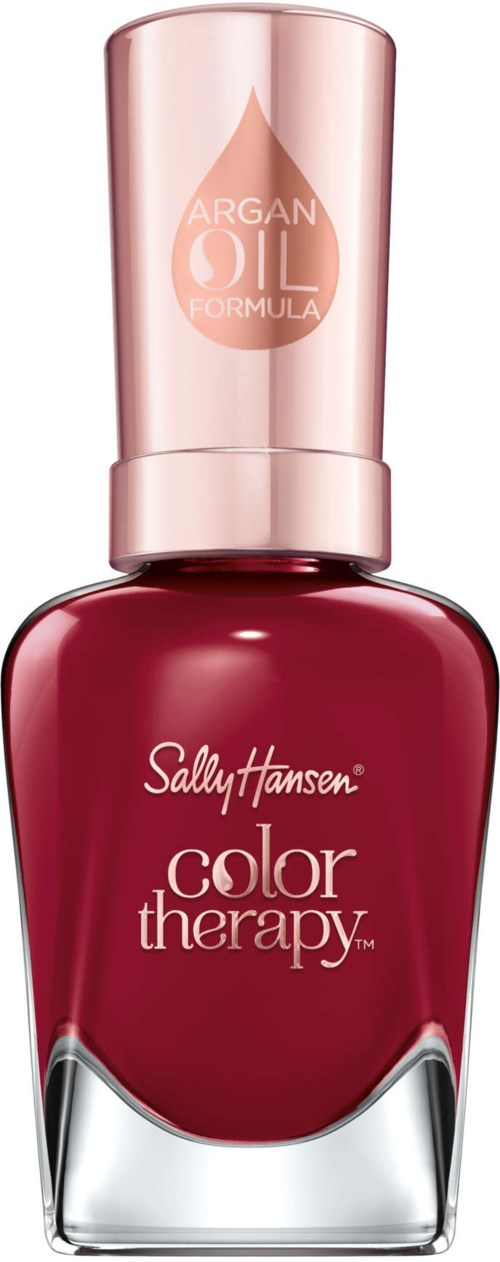 En röd nagellacksflaska med en rosa kork, märkt 'Sally Hansen color therapy' och 'argan oil formula', står upprätt.