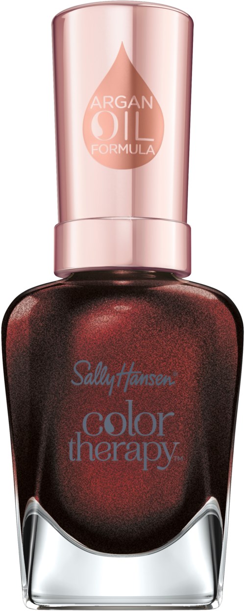 En nagellackflaska i mörkröd färg, rosa lock och etiketter för Sally Hansen och arganolja.