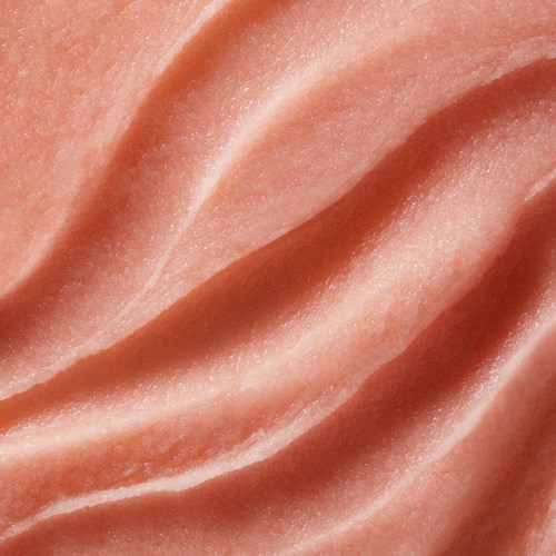 Närbild av rosa, slät, skrynklig yta, möjligen hud eller tyg. Inga andra föremål synliga.