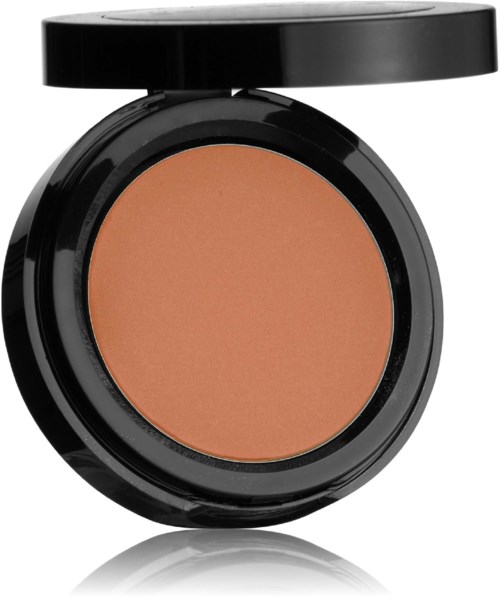 En rund blushbehållare med svart lock, innehållande persikofärgad makeup.
