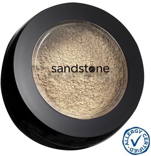 En rund behållare med ljus sand inuti, märkt 'sandsten' och en blå allergimärke.