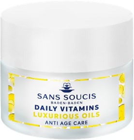 En hvit krukke merket 'Luxurious Vitamins Oil' for anti-aldrings ansiktspleie, med gule detaljer og en blå logo.