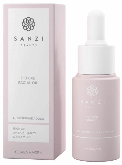 Ruusukuvioinen SANZI Beauty Deluxe Facial Oil -pullo ja sen vieressä laatikko. Se sisältää antioksidantteja ja vitamiineja.