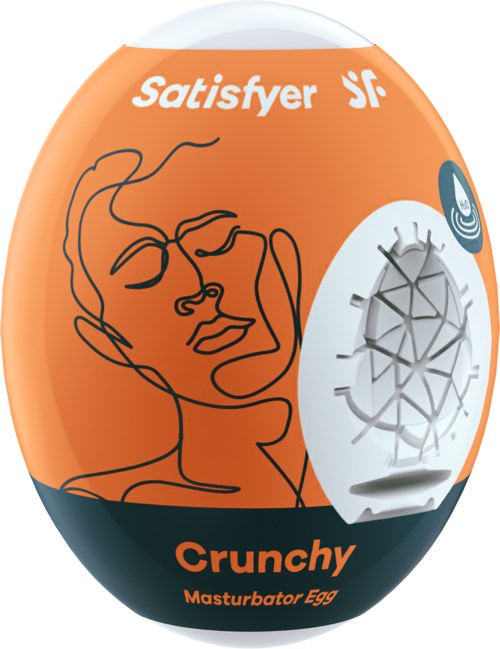Een ovaalvormige verpakking in oranje en zwart met een lijntekening van een gezicht, de woorden "Satisfyer" en "Crunchy" en een klein wit apparaat.
