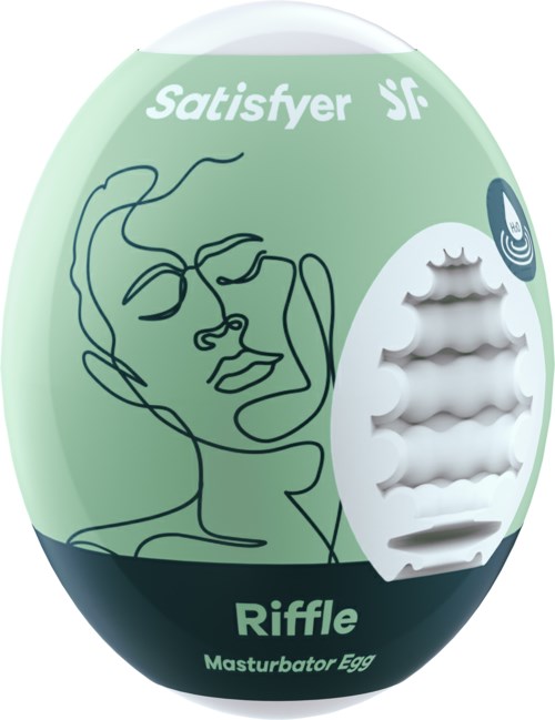 Ympyrän muotoinen rasia kasvojen piirustuksella ja sanoilla, sisältäen Masturbator-munan nimeltä Riffle.