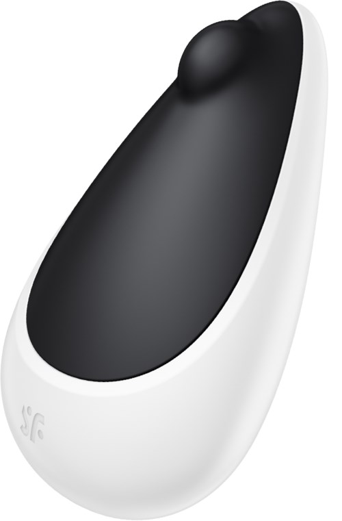 En lille, hvid enhed med en sort, rund, glat overflade, ligner en personlig massage- eller elektronisk enhed.