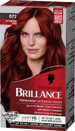 Kvinna med rött hår på hårfärgningsförpackning, ler, med produktdetaljer och varumärket Schwarzkopf Brilliance.