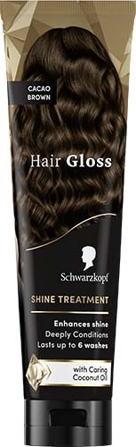 A hair product bottle with dark, shiny, wavy hair on the label offering shine and deep conditioning. Contains coconut oil.