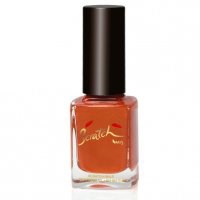 A bottle of orange nail polish with a black cap, labeled with a signature or brand name.