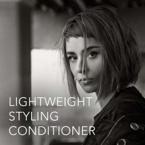 A woman with short hair looks at the camera in a black-and-white photo, with text about a conditioning product.
