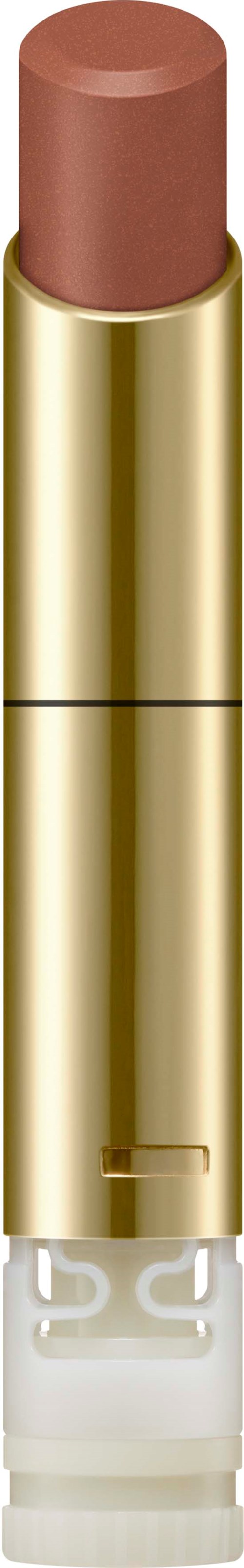 Ein braunes Lippenstift in einem goldenen Gehäuse mit durchsichtigem Boden und weißen Details.