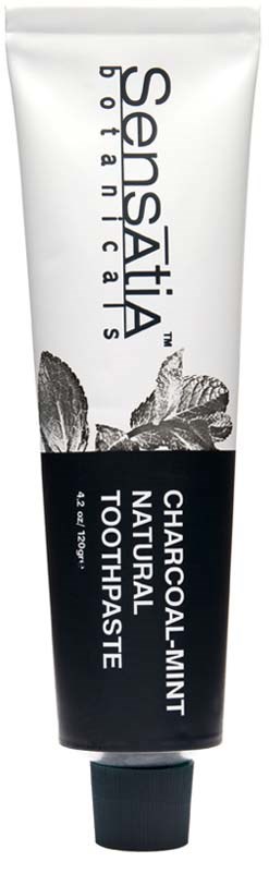 A tube of natural charcoal peppermint toothpaste with a black and white label and mint leaf illustration.