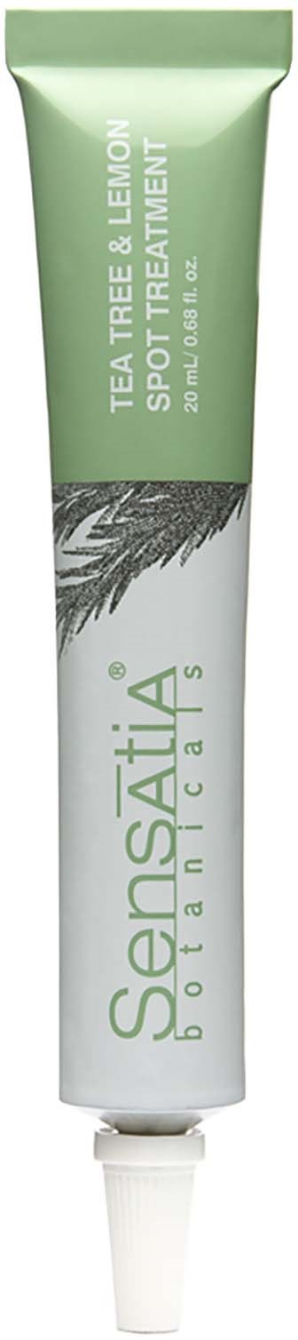 A tube of skincare cream with a green and white label, mentioning tea tree and lemon for spot treatment.