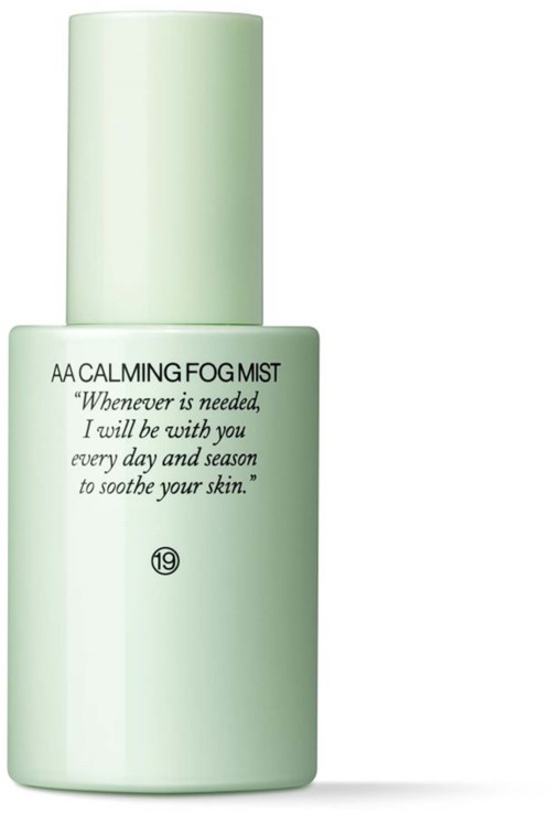 A pale green spray bottle labeled 'AA Calming Fog Mist' with text about soothing skin.