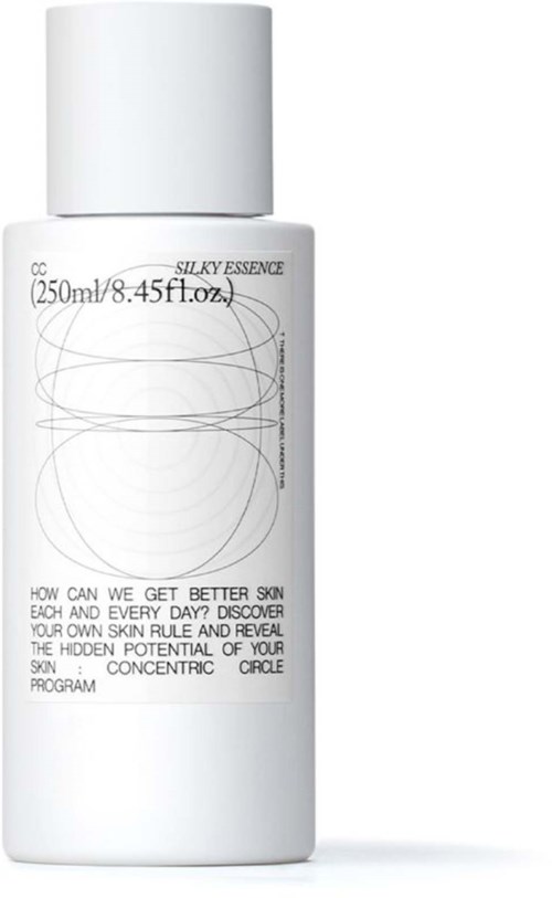 A white bottle of skincare product with text about skin and a simple abstract line design.