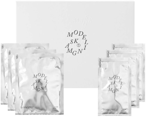 A set of skincare products in shiny silver packages with a white box, featuring the brand name and logo.