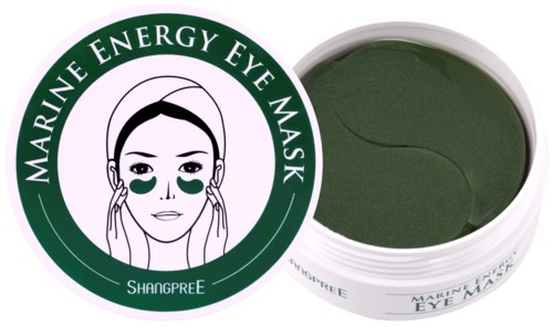En grön ögonmask i en rund behållare, etiketten visar en kvinna som använder ögonmask med text runt. Den säger 'Marine Energy Eye Mask'.