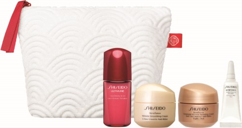 Cosmetic set with a white bag, red bottle, two cream jars, and a small white tube. All are skincare products.