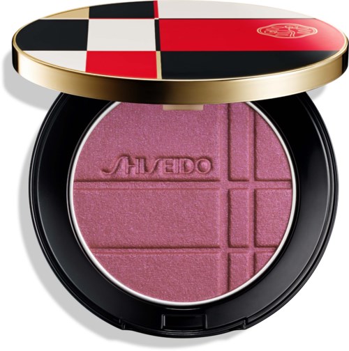 Rosa Puder-Box mit vier Abschnitten und dem eingravierten Namen Aveda, in einer runden Verpackung mit farbigem Deckel.
