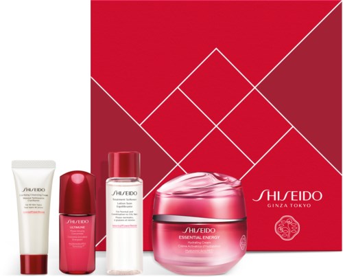 Shiseido Ihonhoitotuotesetti laatikossa, kerma, lotion ja muita pulloja, punaisen ja valkoisen sävyissä.