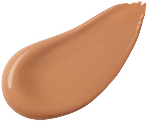 Ett beige-färgat kosmetiskt eller grundläggningsämne är utbrett i form av ett tårdropp.