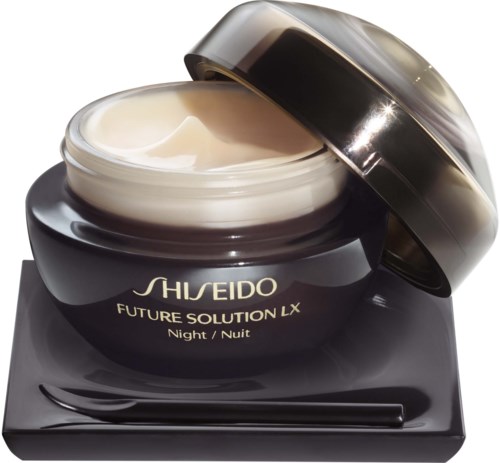 En svart burk med Shiseido nattkräm med locket öppet som visar en krämig substans inuti.