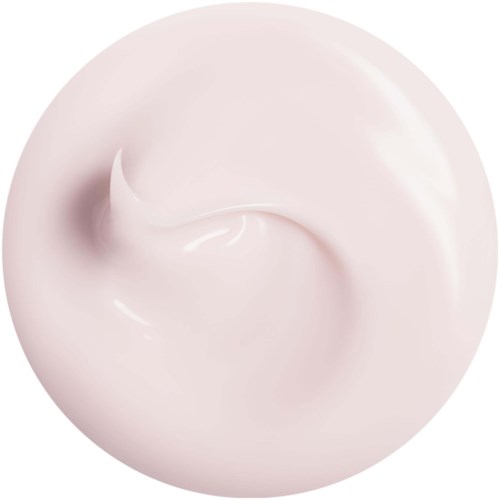 En virvel av ljusrosa kräm eller lotion i en rund form med en glansig yta.