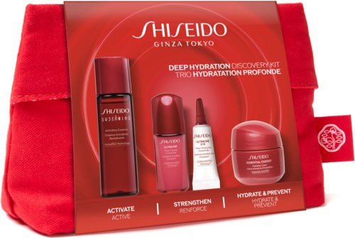 Shiseido hudvårdsset med röd flaska, rosa och vita tuber och en rosa burk i en röd väska.