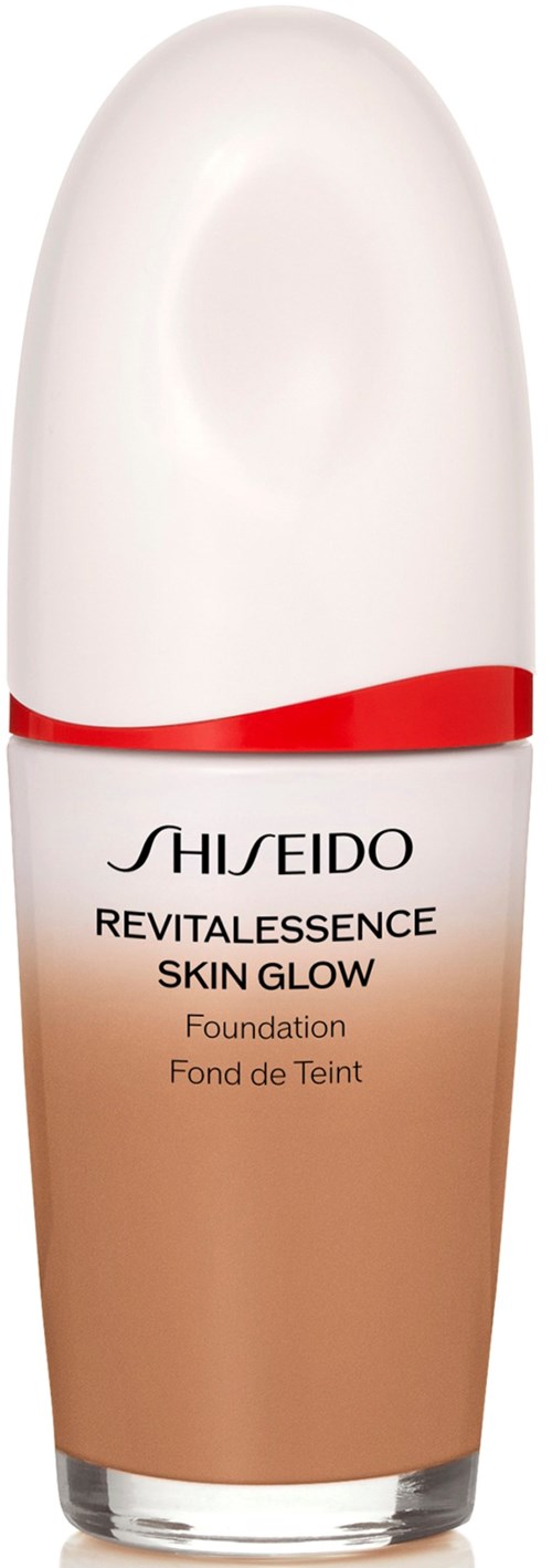 En flaske av Shiseido Revitalessence Skin Glow foundation med hvit hette og beige kropp.