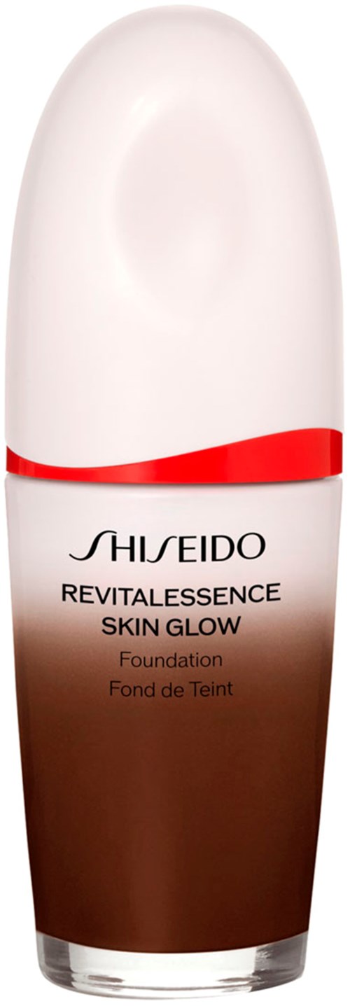 En flaske foundation fra Shiseido, kalt Revitalness Skin Glow, med hvit og brun design og en rød rekke.