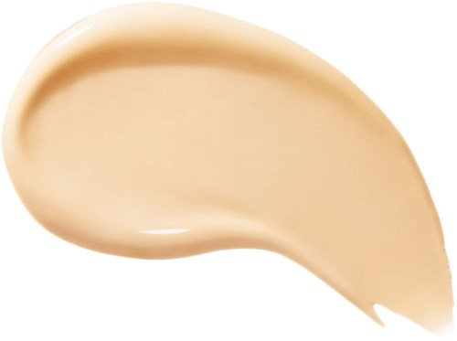 En beigefärgad kräm eller lotion med en slät, tjock konsistens och en kurvad form.