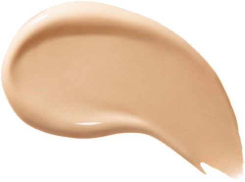 En beige vätska i en böjd form med slät yta.