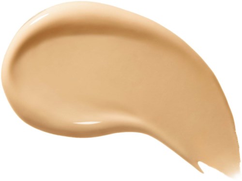 Ett beige kräm eller foundation utbredd i en kurvad form på en vit bakgrund.