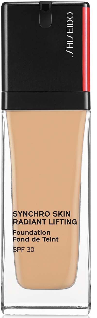En foundationflaska med svart lock, genomskinlig kropp som visar beige foundation och en röd accent på locket.
