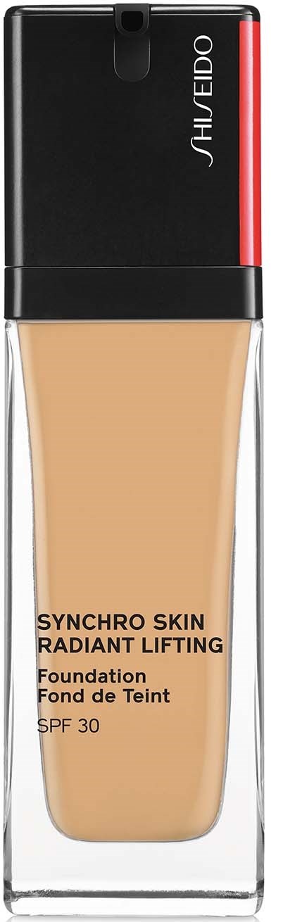 En flaska foundation med svart lock, några ord på den och en klar kropp som visar ljusbeige vätska inuti.