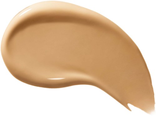 En beige, flytande kräm eller grundfärg med slät textur och rund form.