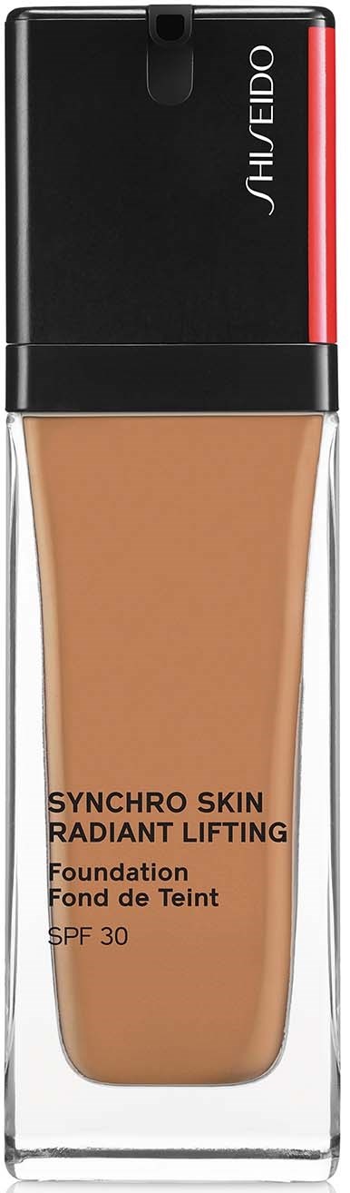 En foundationflaska med svart, röd och klar topp, märkt Shiseido Synchro Skin Radiant Lifting SPF 30, beige färg.