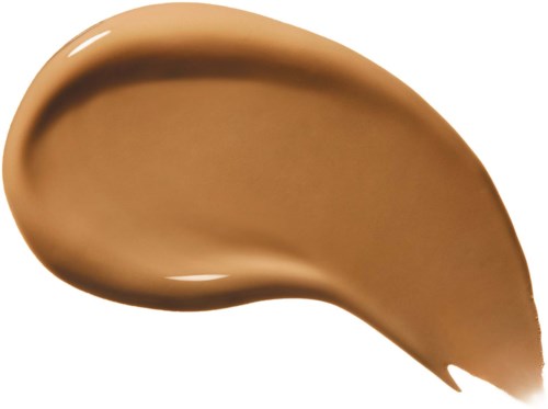 En tjock linje av beige flytande smink, slät och glänsande, formad som en sked eller en tår.