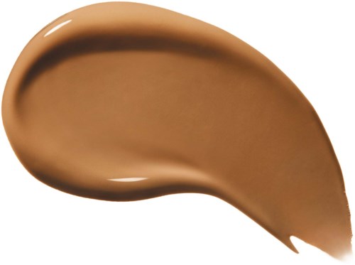 Ett drag av ljusbrun eller beige makeup eller foundation på en vit bakgrund.