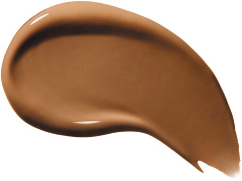 En brun makeup- eller hudvårdsprodukt, lagd i en tårformad form med en glänsande yta.