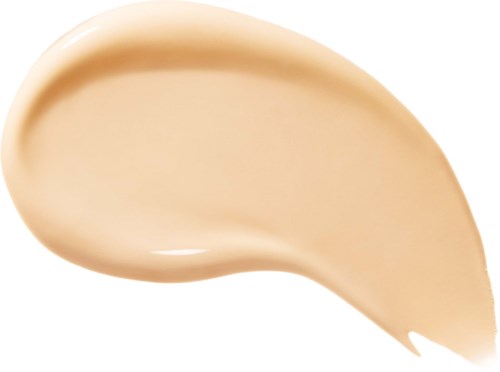 En beige färgad kräm spridning i en kurvig form på en vit bakgrund.