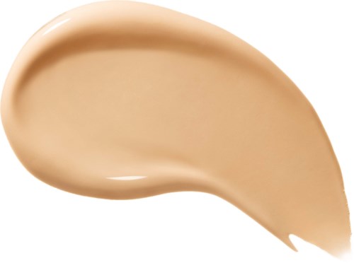Et spor av lys beige væske, jevn og kremaktig, med en buet form på hvit bakgrunn.