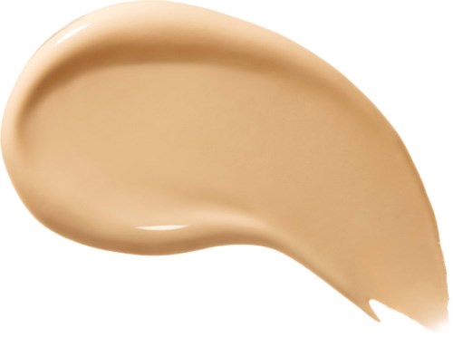 En virvel av beige væske, sannsynligvis sminke eller foundation, på en hvit bakgrunn.