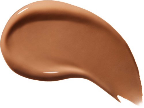 Et strøk av beige-brun væske eller krem med glatte, flytende kanter og en skinnende overflate.