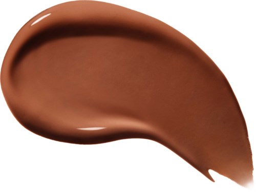 Glatt, brun, buet kosmetisk produkt som ligner foundation eller krem, med glatt tekstur.