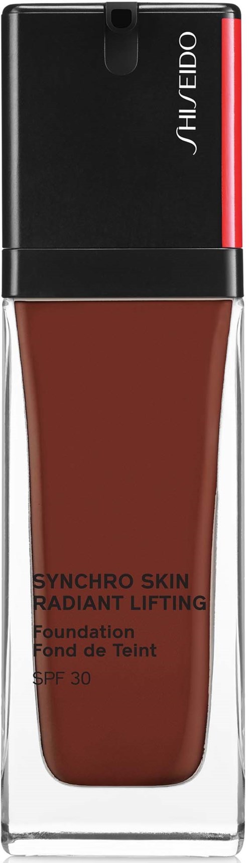 En foundationflaske med svart og rødt lokk, merket 'SYNCHRO SKIN RADIANT LIFTING' av Shiseido.