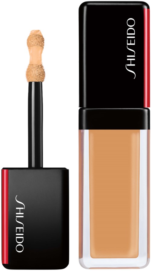En flaske med flytende foundation og en applikator med svamp på en pinne. Merket er Shiseido.
