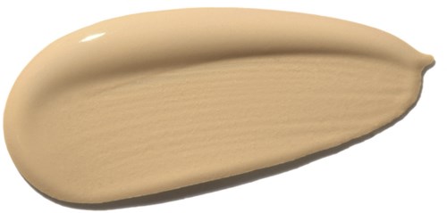 Ein beigefarbiger flüssiger Make-up-Probel auf schwarzem Hintergrund.
