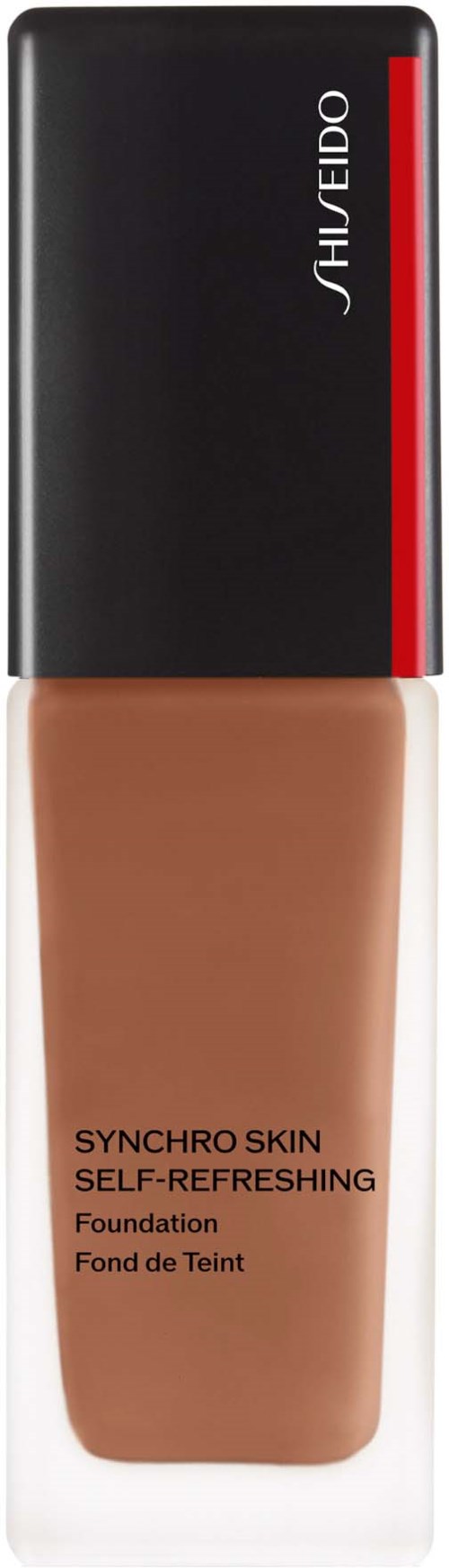 En flaska med foundation, svart lock, röd rand och beige vätska.